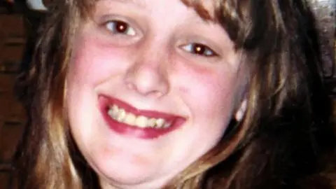 Charlene Downes, with long brown hair, smiles for the camera in a photo released by her family.