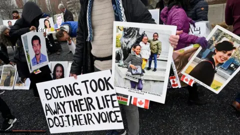 AFP via Getty Images Families and friends who lost loved ones in the March 10, 2019, Boeing 737 Max crash in Ethiopia, hold a memorial protestwitha sign saying Boeing took away their life, DOJ their voice in front of the Boeing headquarters in Arlington, Virginia, on March 10, 2023 to mark the four-year anniversary of the event