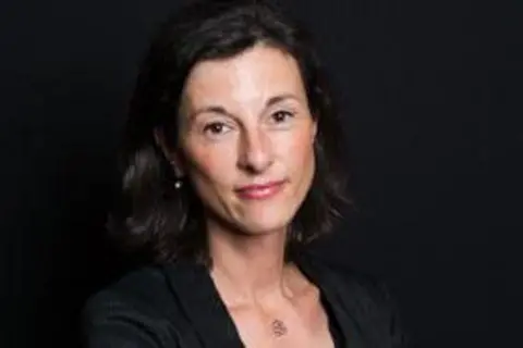 Anne-Laure Domenichini Anne-Laure Domenichini is pictured against a dark background. She has dark hair, dark dress and is standing with her arms crossed 