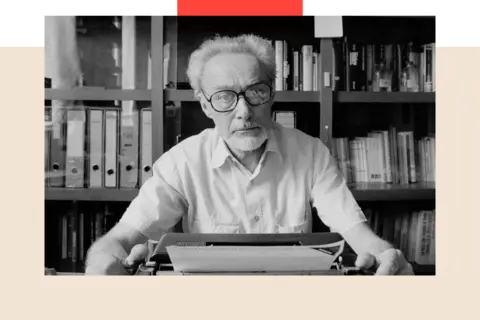 Getty Images Author, Primo Levi, successful  1986, sitting successful  beforehand   of a bookshelf with a typewriter