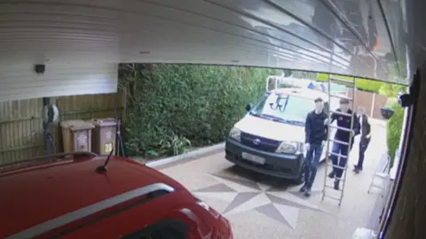 Alan Graves CCTV footage of three men using a ladder to climb onto a roof