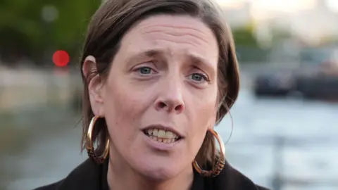 Getty Images Jess Phillips has short brown hair tucked behind her ears. She is wearing a dark jacket and is forwards.