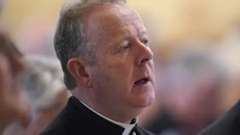 PA Media Archbishop of Armagh Eamon Martin wearing black top, with white clerical collar.