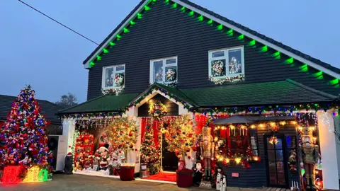 The Hedges family home in Gillingham festooned with lights and Christmas decorations.