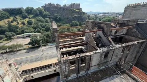 A general view of the wrecked builing on Princes Street showing exposed steelwork and brick.