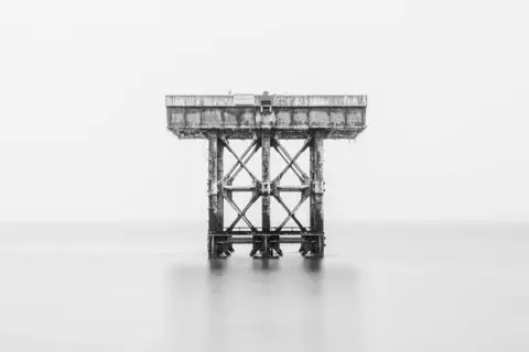 Keith Brooke A steel platform stands in a calm sea