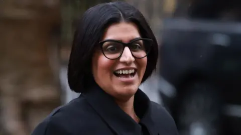 EPA/Shutterstock Home Secretary Shabana Mahmood walking in Downing Street. She is wearing a black coat and black glasses.