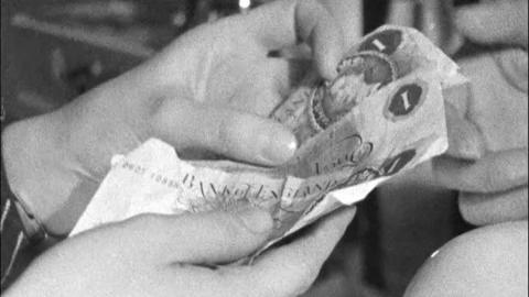 A hand holds paper money