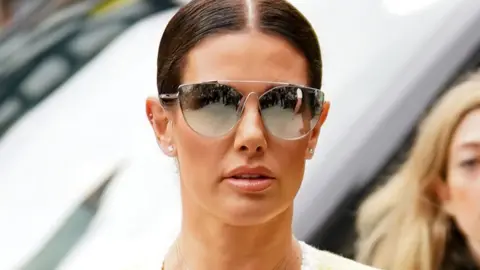 PA Media Rebekah Vardy outside court in 2022 wearing reflective shades
