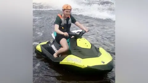 Family handout Ellis Cox riding a personal watercraft