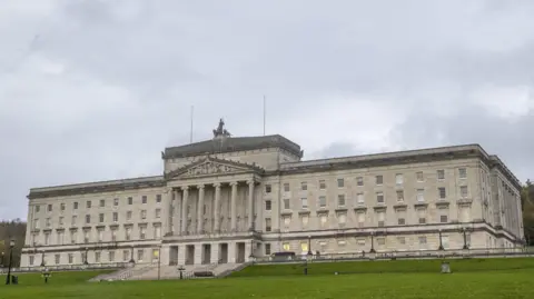 PA Media A stock image of Parliament Buildings at Stormont Estate, in Northern Ireland - it is a large white/grey building.