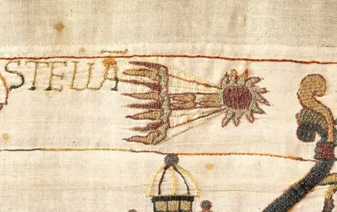 Bayeux Museum A closer crop shows the comet racing through the sky next to letters reading 'Stella' and fabric texture detail.