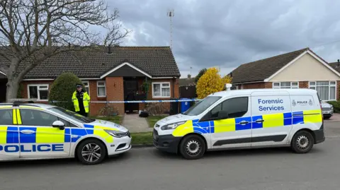 Shaun Whitmore/BBC Forensic services outside the house of the woman who died in Pakefield, Suffolk