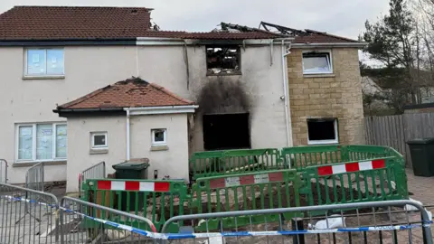 A general view of the fire-damaged house in the Hay Drive area of Niddrie.