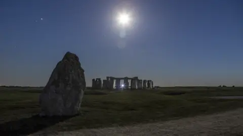 A picture of the Moon, high above Stonehenge 