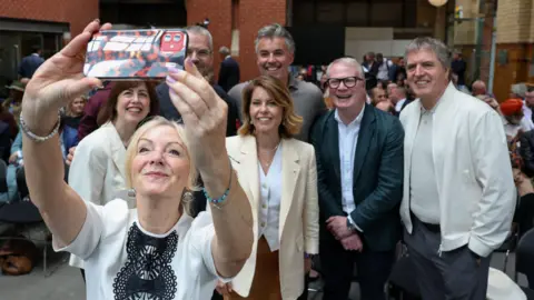 Reuters West Yorkshire Mayor Tracy Brabin takes a selfie with Labour Party deputy leader Lucy Powell, North East Mayor Kim McGuinness, West Midlands Mayor Richard Parker, Liverpool City Region Mayor Steve Rotherham, South Yorkshire Mayor Oliver Coppard, and York and North Yorkshire Mayor David Skaith on the day Andy Burnham, British member of parliament (MP) for Makerfield, delivers a speech at the People's History Museum in Manchester, Britain, June 29, 2026.