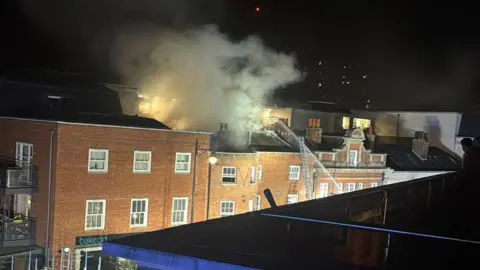 Maidenhead High Street flats fire - smoke seen coming from roof of building.