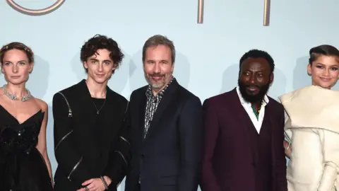 Getty Images Rebecca Ferguson, Timothée Chalamet, Denis Villeneuve, Babs Olusanmokun and Zendaya at a London screening of Dune in 2021