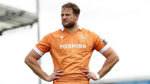 Sale Sharks' Jonny Hill stands with hands on hips looking on after the end of a match