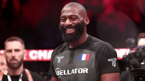 Cedric Doumbe celebrates beating Jaleel Willis at the Bellator Champions Series
