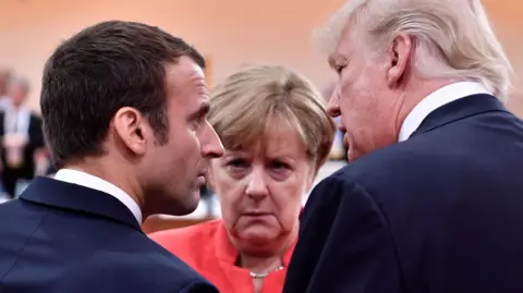 Getty Images Angela Merkel with Donald Trump and Emmanuel Macron