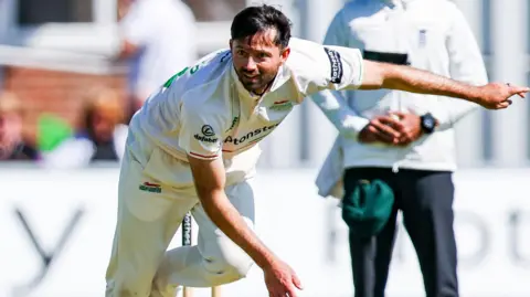 Leicestershire skipper Ian Holland bowling in his whites at Grace Road