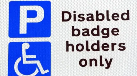 Jonathan Brady Disabled badge holders only sign with a P in blue and an icon of a person in a wheelchair