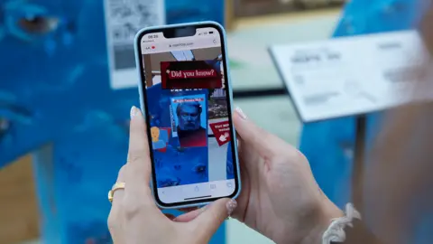 Alwynphoto A visitor explores the 'Night Sweats Nick' character through AR experience