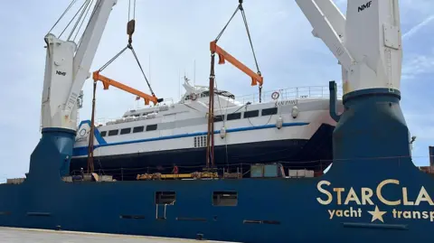 The San Pawl ferry being loaded on to a much larger boat. 