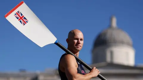 Getty Images Sam Murray holding an oar over his shoulder, which has a Union Jack on it