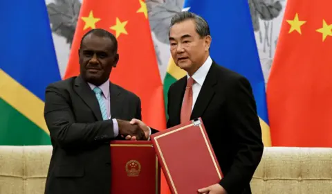 Reuters  Jeremiah Manele shaking hands with China's foreign foreign minister Wang Yi in a 2019 meeting in Beijing