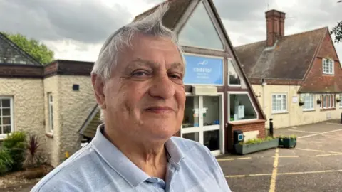 Andrew Turner/BBC Mel Catton, chairman of Wells Town Council, outside the Wells Coastal Health & Wellbeing building