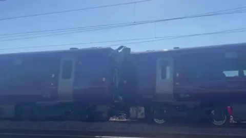 An image showing two train carriages which appear to have crashed 