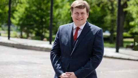 Newcastle City Council Councillor Alex Hay, Newcastle City Council cabinet member for a resilient city, smiling at the camera