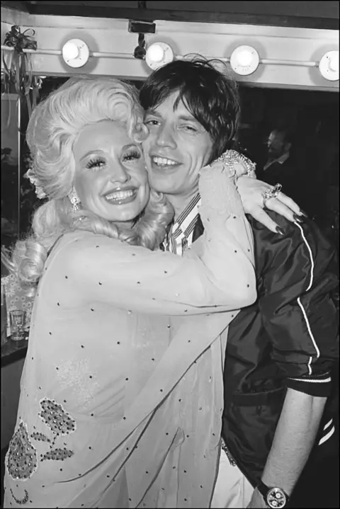 Getty Images After her performance at the Bottom Line, American Country musician Dolly Parton is seen hugging British rocker Mick Jagger backstage, New York, New York, May 14, 1977
