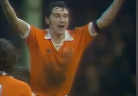 Mickey Walsh a tangerine shirt celebrates his winning goal