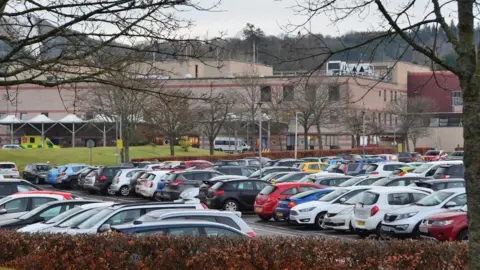 Jim Barton A busy car park with a hospital building in the background
