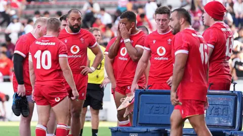 Wales players dejected after defeat to Japan