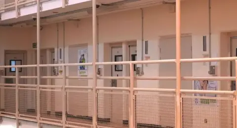 Ant Saddington/BBC A row of cells on a landing at HMP Woodhill