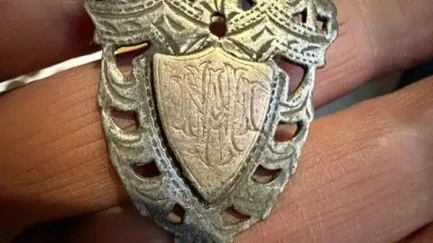 Alex Farrow Picture of a silver necklace brooch which Farrow found in Ramsbottom. The initials MW is engraved on the front.