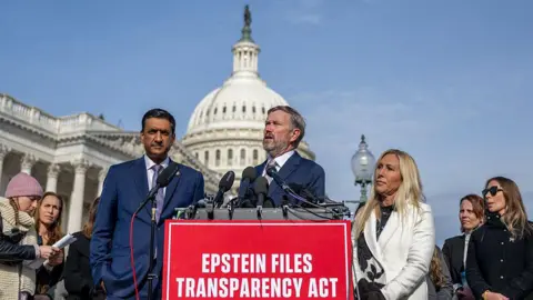 Members of Congress stand outside Capitol and behind sign that reads “Epstein Files Transparency Act” 