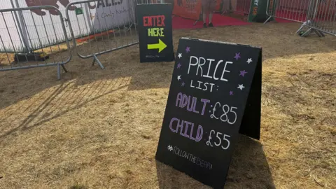 George King/BBC A blackboard with the words Price List: Adult £85 Child £55 written on it. 