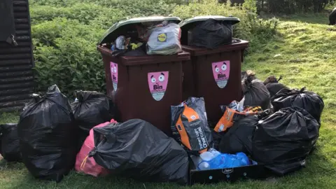 Darren Rozier/BBC Rubbish left near a bin at Needham Lakes