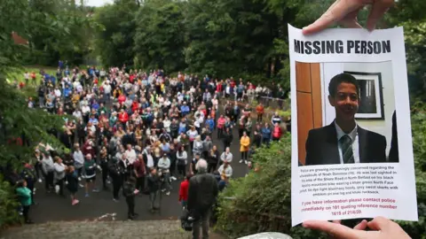 Pacemaker Press A 'missing person' poster with Noah's face on it. In the background is a large group of people which were part of the search operation.