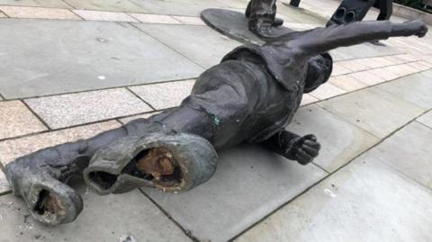 Toppled statue