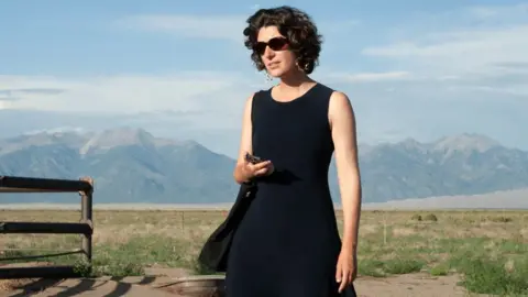 Julia Andreone Artist Marguerite Humeau pictured outdoors with mountains in the background