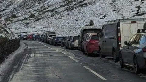 Cars parked along the road at Pen y Pass in Eryri National Park
