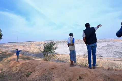 Goldman Environmental Prize Alok looks over a mine in the forest
