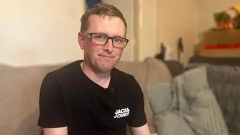 Robert Butler sitting at home on the sofa