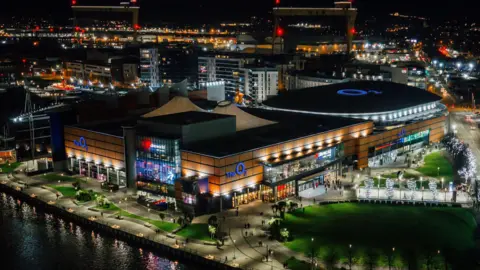 The image features a conceptual design of some of the locations where O2's logo will be displayed externally across the site, formerly known as the Odyssey complex